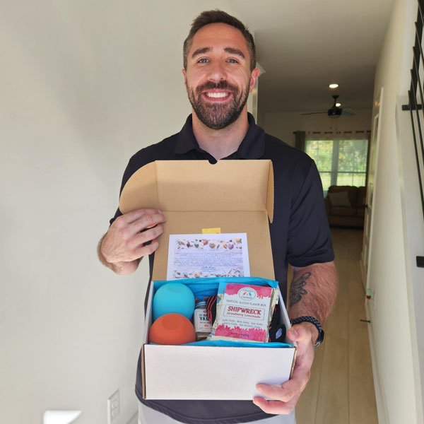 A middle-aged guy holding a Hello Again Box