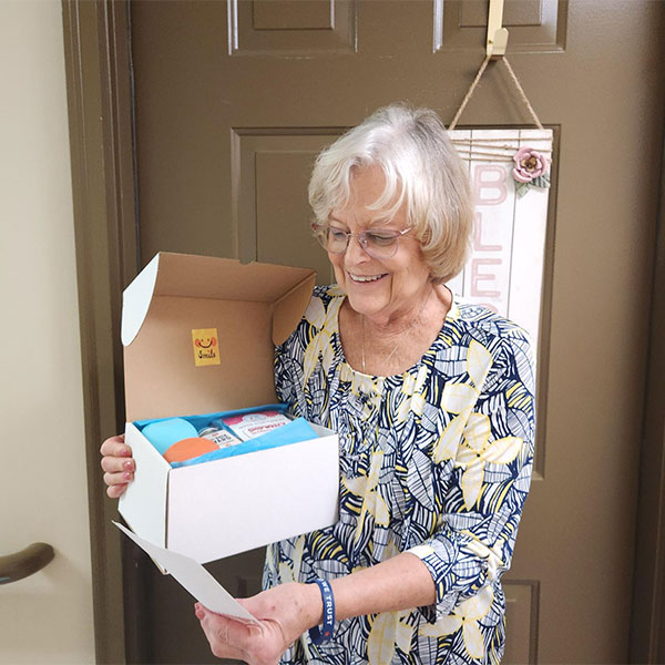 Judy, holding Hello Again Box