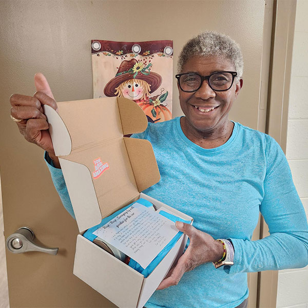 Martha, holding Hello Again Box